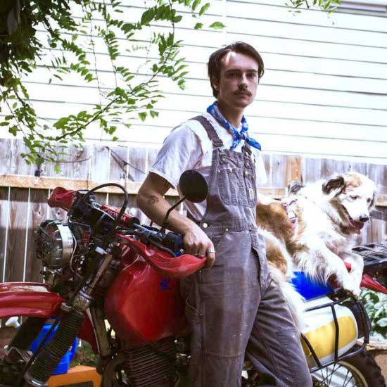 Griffin Washburn in his bike with his dog